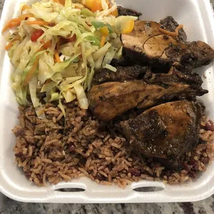 Jerk chicken, rice n peas, and stir-fried vegetables.