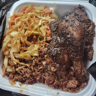 Jerk chicken with red beans and rice with veggies.