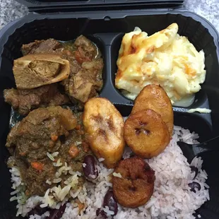 Curry goat with macaroni, rice and beans, and plaintains. $14 ($2 extra for the third side)