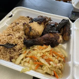 Jerk chicken combination plate with cabbage and beans and rice