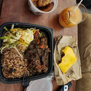 Oxtail dinner, cabbage, beans and rice, side of plantains, and a beef pattie.