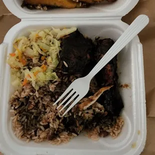 Jerk chicken, beans and rice, cabbage, and plantains