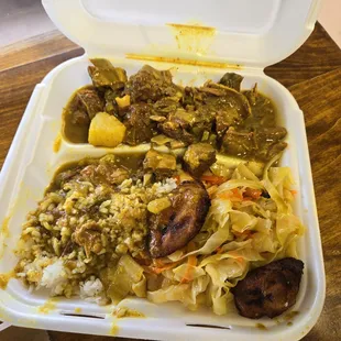 Curry goat, white rice, cabbage, and plantains