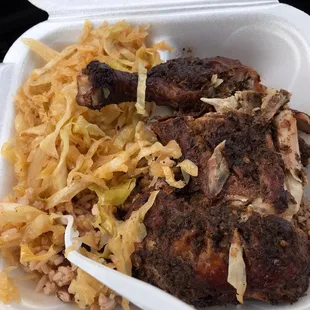 Jerk chicken plate side of cabbage and rice and peas