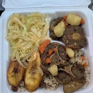 Ox tail potatoes and carrots, cabbage, plantains rice and pinto beans.
