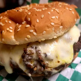 a hamburger with cheese and onions