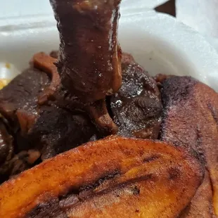 Oxtails and plantain, yes that's a microsize oxtail