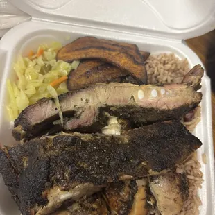 Lunch meat combo. Jerk Chicken with Rice and Beans, jerk ribs, cabbage, plantains.