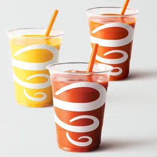 three cups of juice with straws