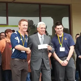 Robert gives check to UCI Soccer teama