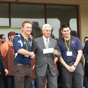 Robert gives check to UCI Soccer team