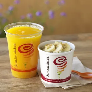 a cup of ice cream next to a cup of orange juice