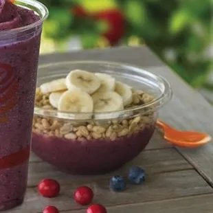 a smoothie and a bowl of fruit