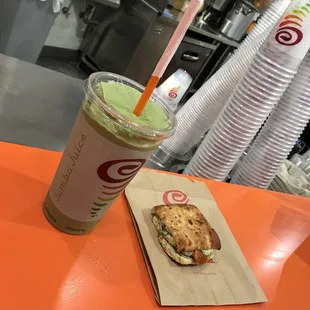 a sandwich and a drink on a table