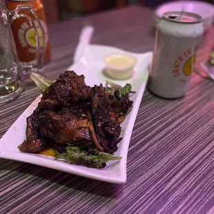 a plate of food and a can of beer