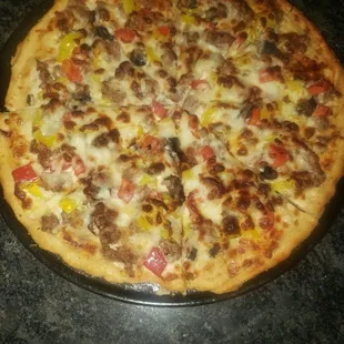 pizza with sausage, tomato, onion and peppers. I love the pizza&apos;s from here and they have a great deal on weds!