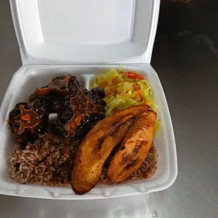 Ox tail, rice with beans/peas, cooked cabbage and carrot medley, fried plaintain --so delicious! This was their small size.