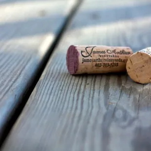 two wine corks on a wooden table