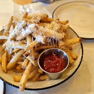 a plate of french fries and a glass of wine