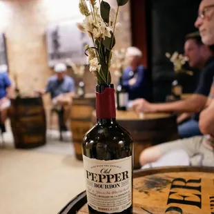a wine bottle with flowers in it