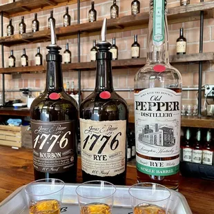 three bottles of whiskey and two shot glasses