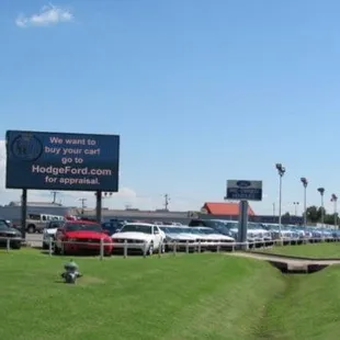 HodgeFord.com sign in front of New Cars.