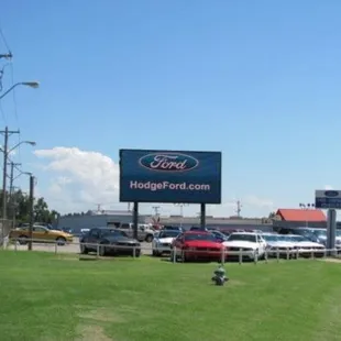 HodgeFord.com sign in front of New Cars.
