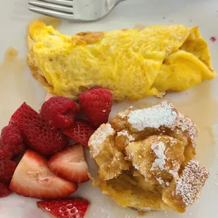 A kids breakfast plate with cheese omelet, fresh berries,  and french toast with mango and apricot inside. Yummy!
