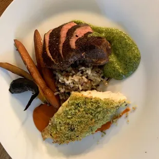 Duo of Cilantro crusted tilapia with Rojo mojo, tri tip steak w/ classic mojo verde, wild rice and honey glazed baby carrots.