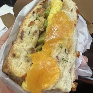 Avocado egg and cheese on a bacon chive biscuit.