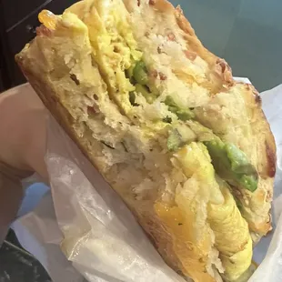 Avocado egg and cheese on a bacon cheddar chive biscuit. I just had to take a bite.