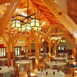Majestic-pine-framed dining room with fireplace accommodates 140 persons for meals. Full commerical kitchen