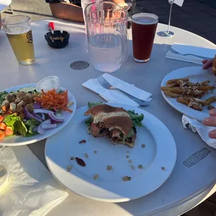 a table with plates of food and drinks