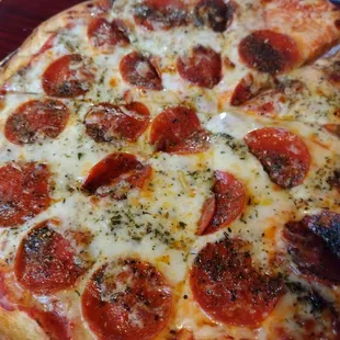 a pepperoni pizza on a table