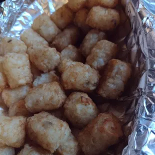 a close up of a foil wrap of tater tots