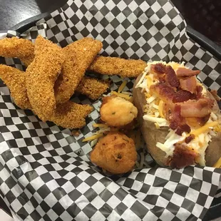 Catfish dinner with a loaded baked potato.