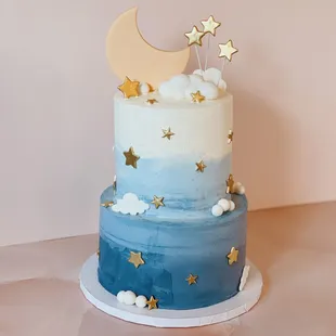a blue and white cake with gold stars