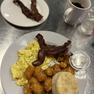 Eggs bacon tater tots and a biscuit.