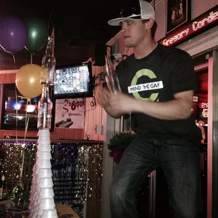 a man standing in front of a stack of cups