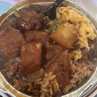 Jerk chicken platter with rice n peas, mac n cheese and greens. delish!