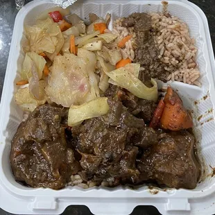 Oxtails with cabbage and rice &amp; peas