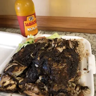 a plate of food and a bottle of jamrock