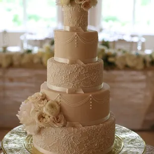 Gorgeous traditional wedding cake with fresh flowers and hand piped lace accents