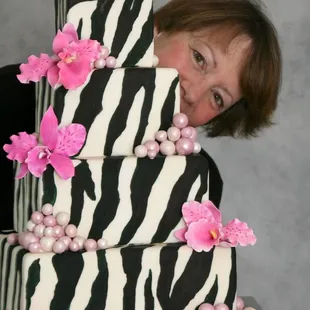 Jan peeking from behind a fierce zebra cake
