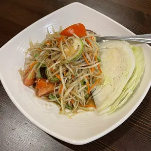 a white plate with a salad on it