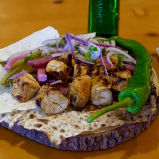 a flatbread with chicken and vegetables