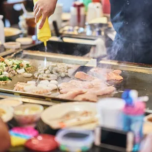 a man cooking food on a grill