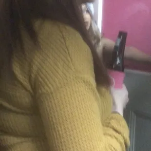 The door being held open by employee that has a clear "W" while woman are occupying bathroom