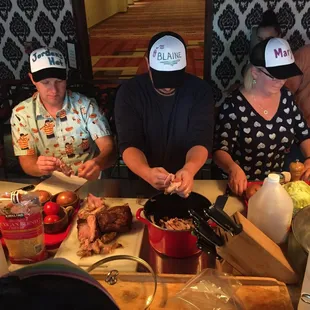 Taco team building class, pulling pork for tacos.