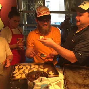 Making fruit filled empanadas in Taco team building class.